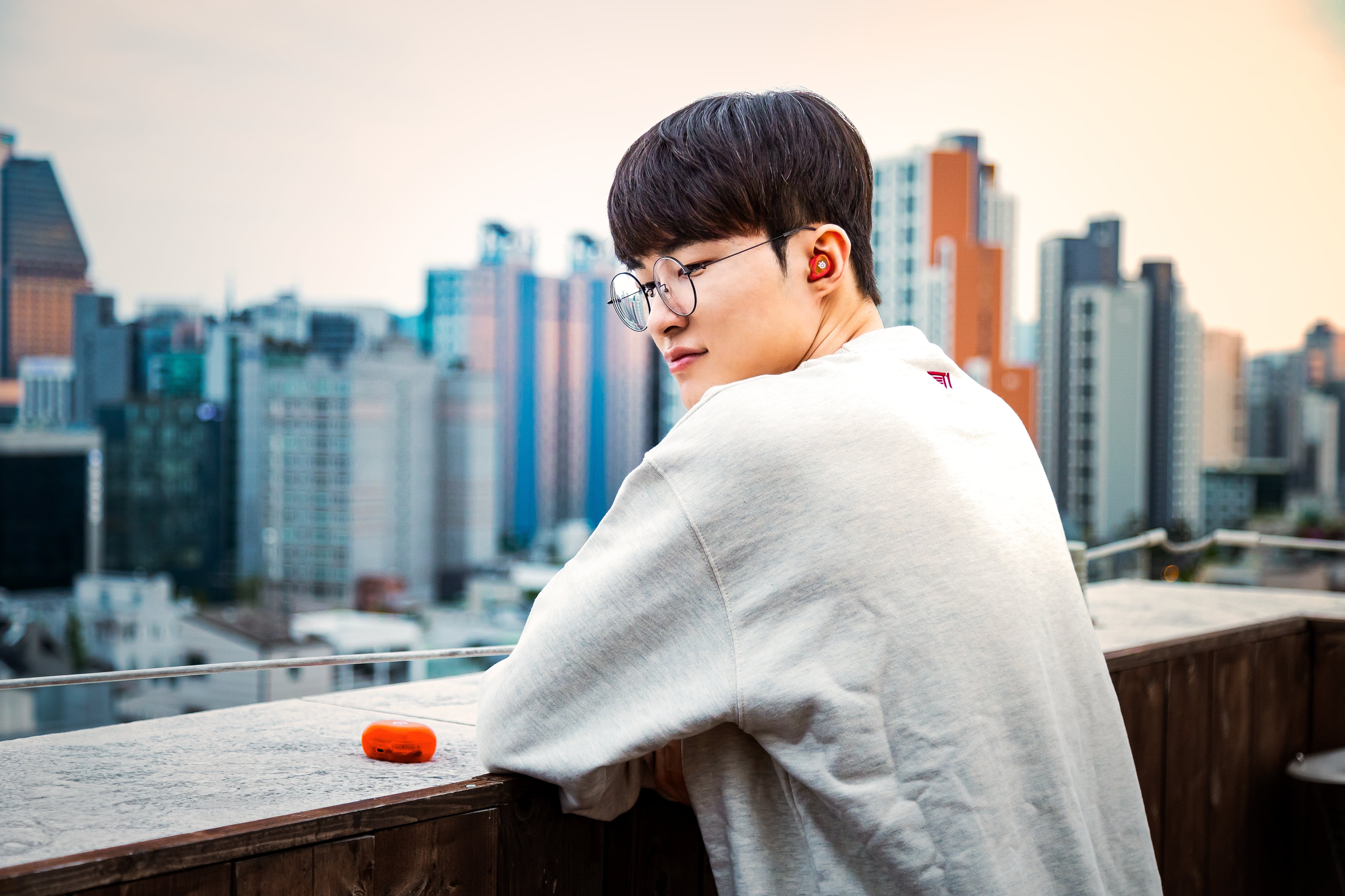 A lifestyle shot of the Glorange SteelSeries Arctis Gamebuds.