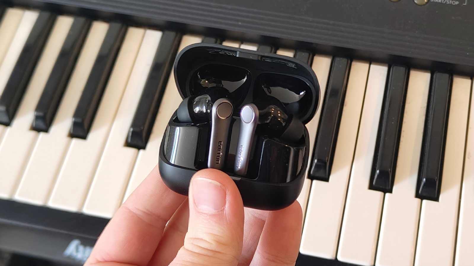 The Earfun Air Pro 4 Plus on top of a keyboard.