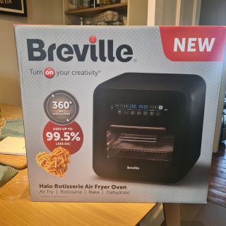 A boxed Breville Halo Rotisserie Air Fryer on kitchen counter