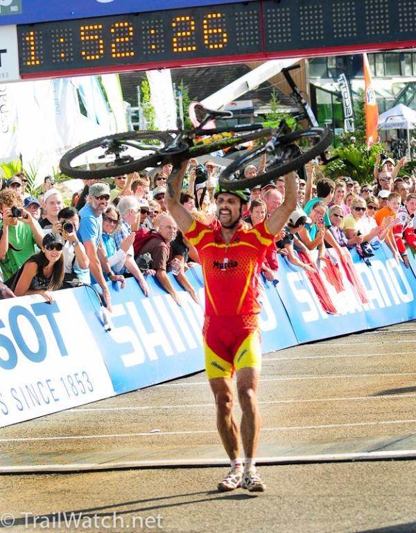 Jose Antonio Hermida Ramos (Spain) carrying his bike across the line.