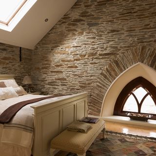 attic bedroom with stone walls
