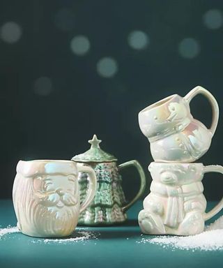 Merry Luster Stoneware Mugs against a blue background.