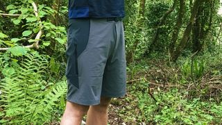 A man wearing Rapha Explore Shorts in a wood