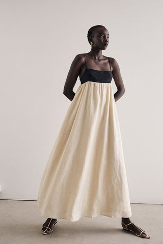 Dissh model wearing cream and black maxi dress