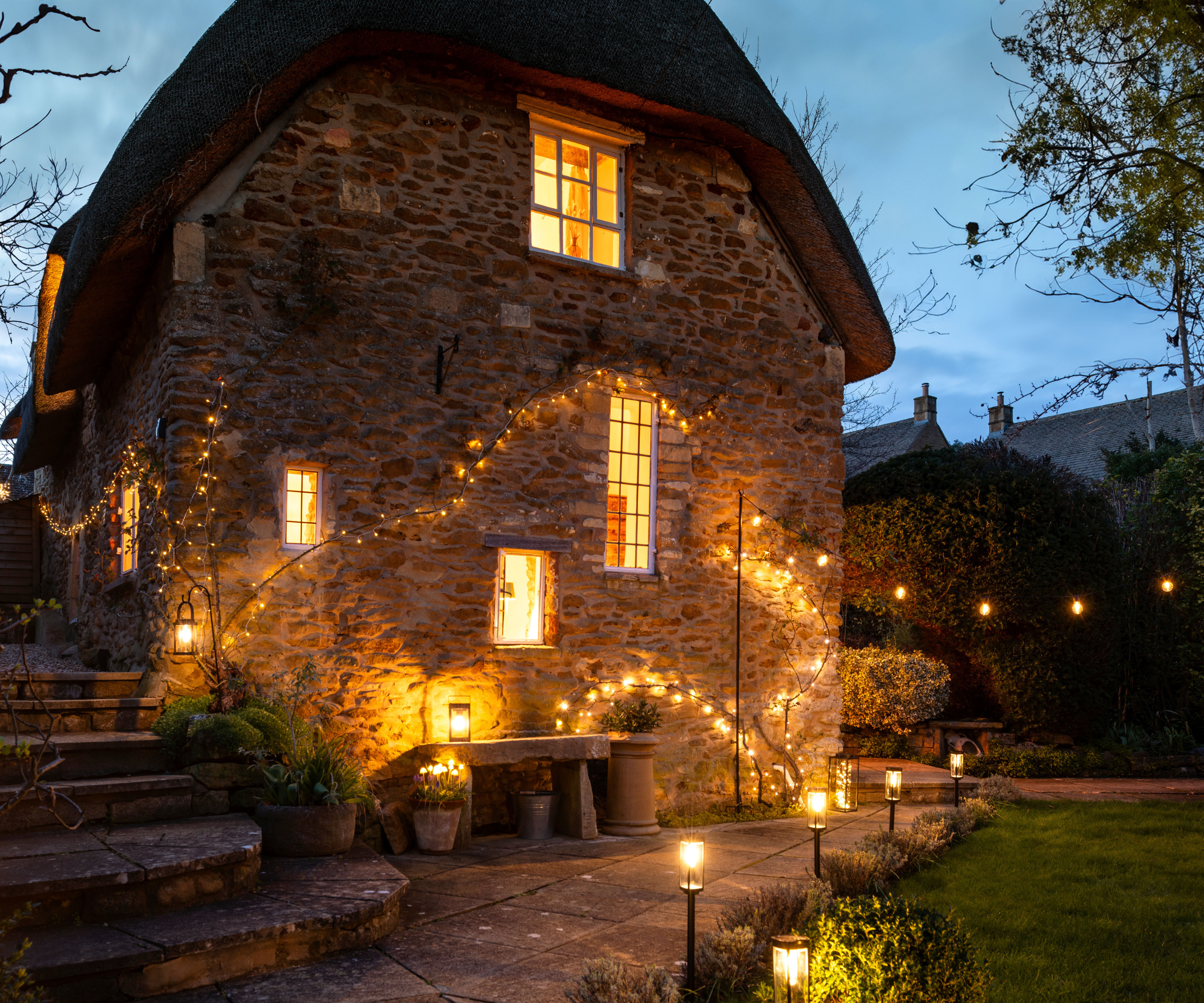 brick house with lighting in the garden