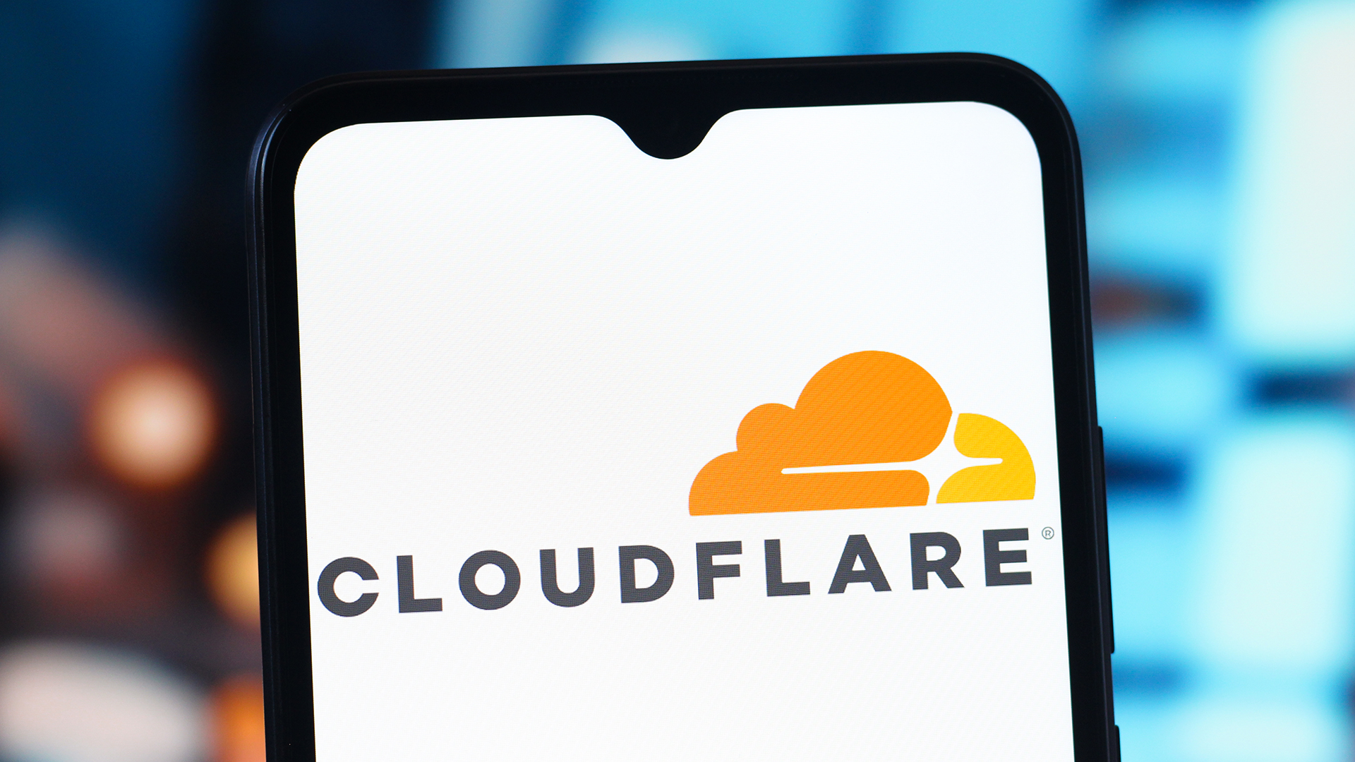 The Cloudflare logo shown on a phone.