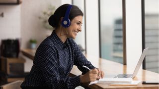 Woman on video call wearing bluetooth headset