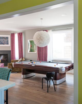 Colorful basement space with a pool table