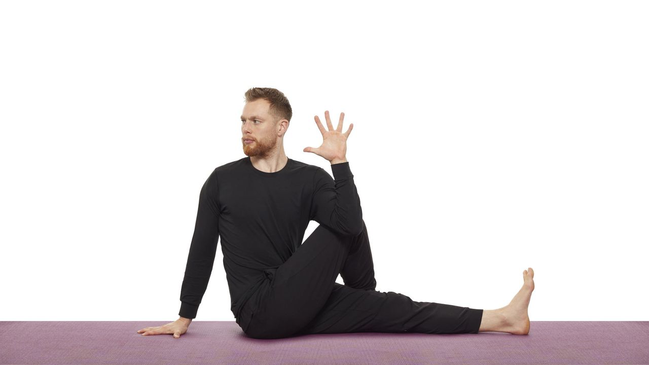 Yoga teacher Nick Higgins performs a seated twist