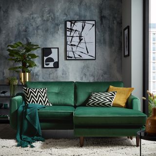 living room with green sofa and frame on wall