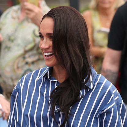 Meghan Markle wearing a blue striped shirt