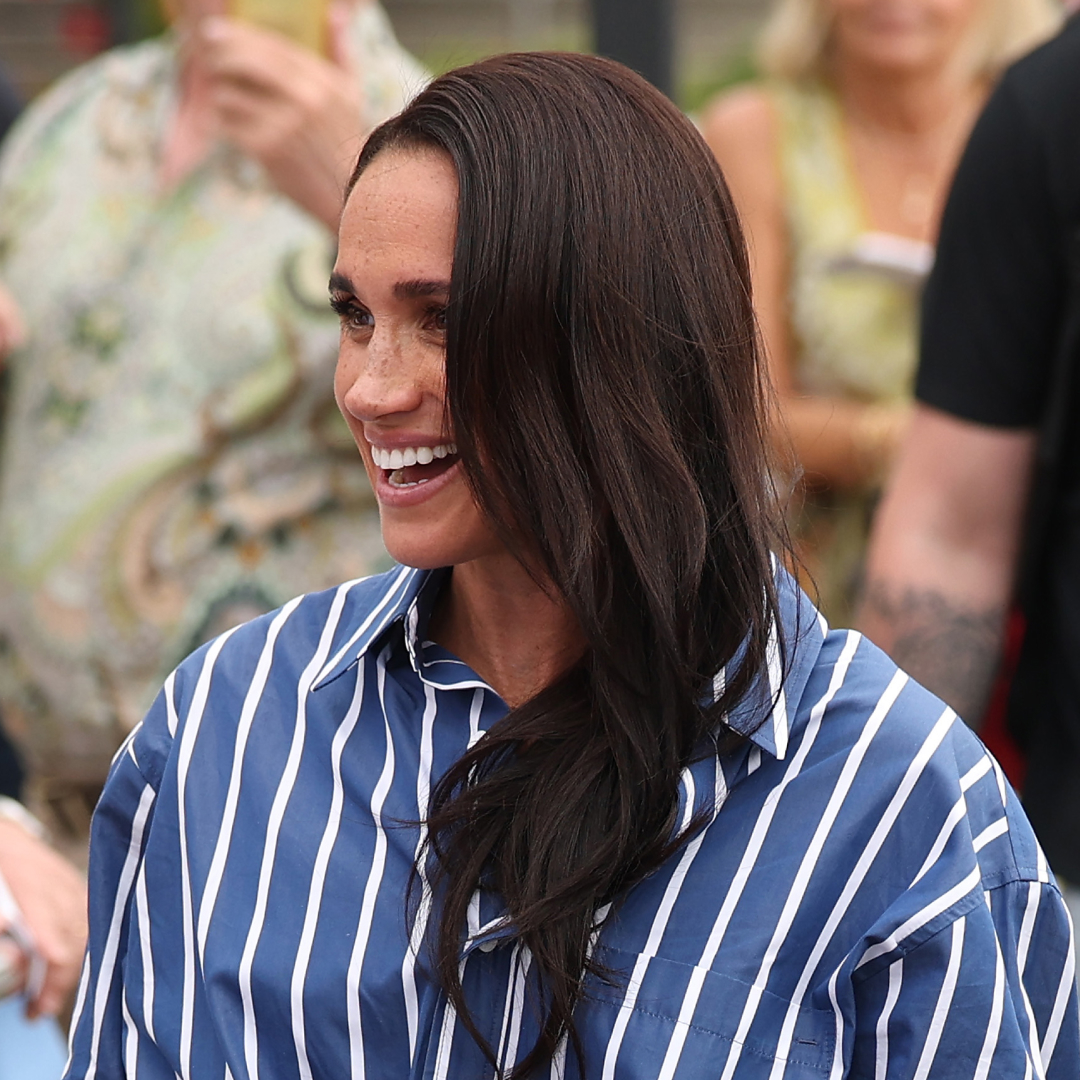 Meghan Markle wearing a blue striped shirt