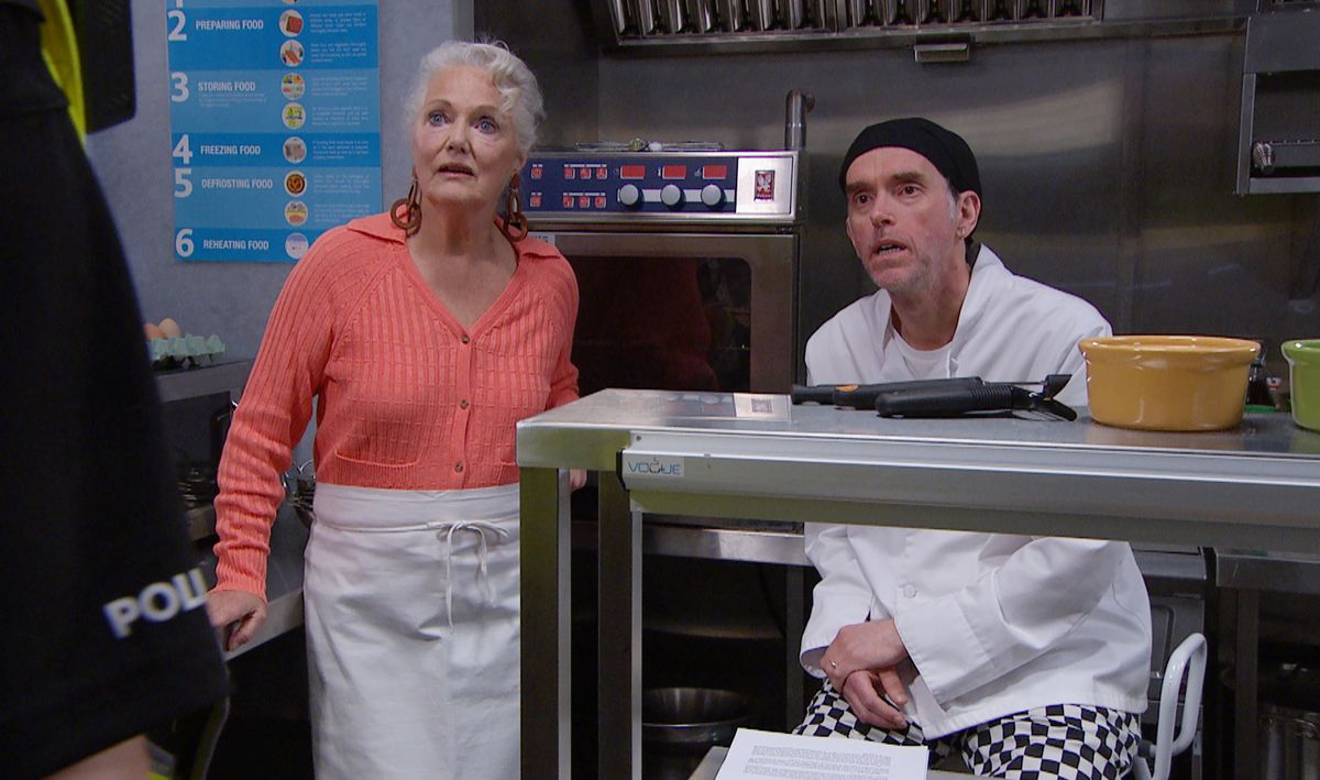 Mary Goskirk looking shocked in the Woolpack kitchen in Emmerdale. 