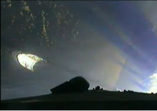 This still from an Arianespace broadcast shows the shell-like nose cone, or payload fairing, falling away to the left after the launch of an Ariane 5 rocket carrying the new ATV-3 cargo ship for the International Space Station on March 23, 2012.