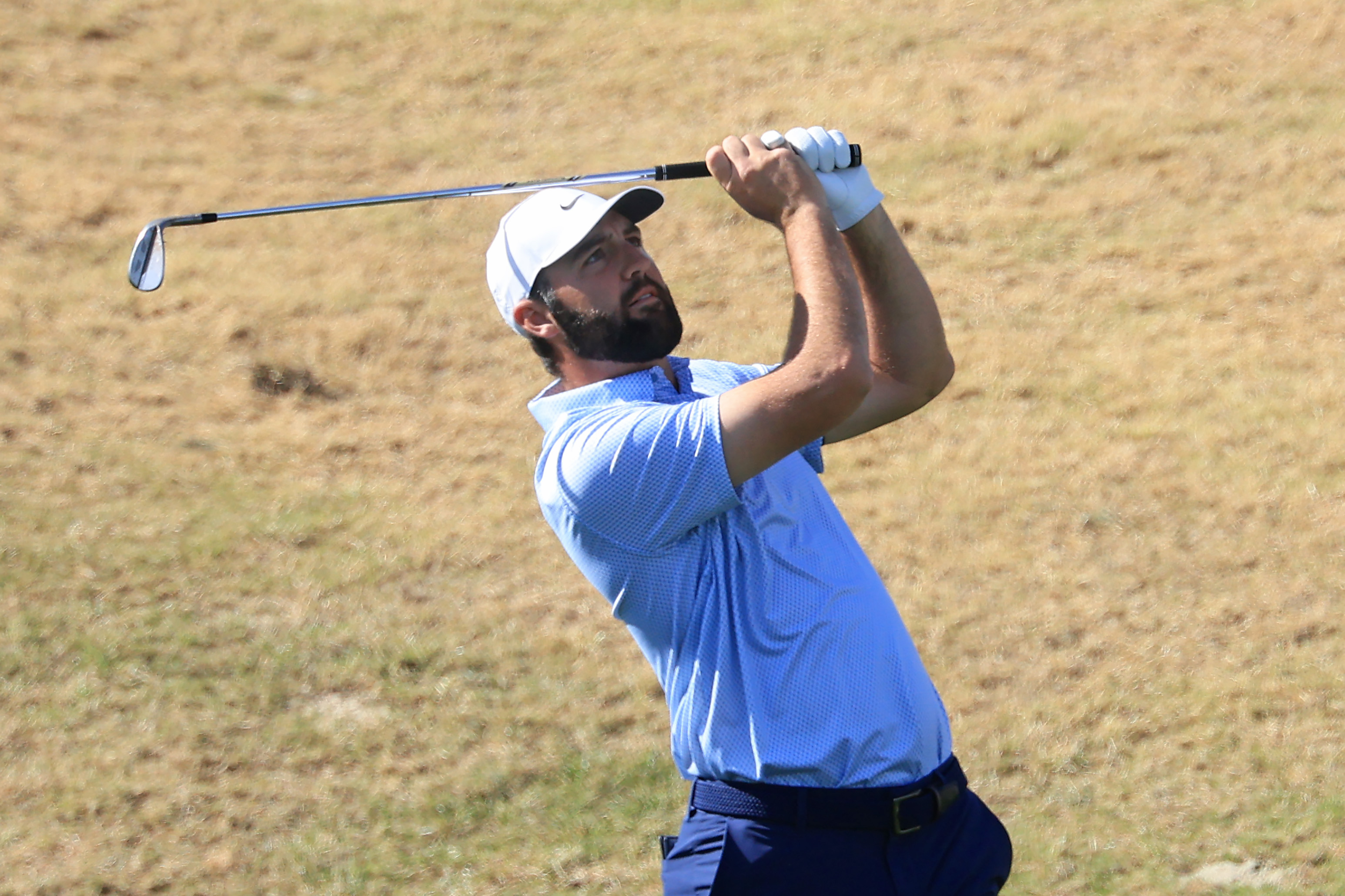 Scottie Scheffler watches his wedge shot