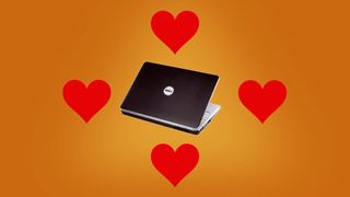 Black dell laptop surrounded by four red hearts
