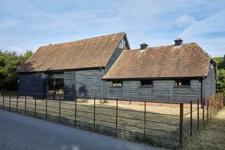 black timber cladding on listed barn conversion