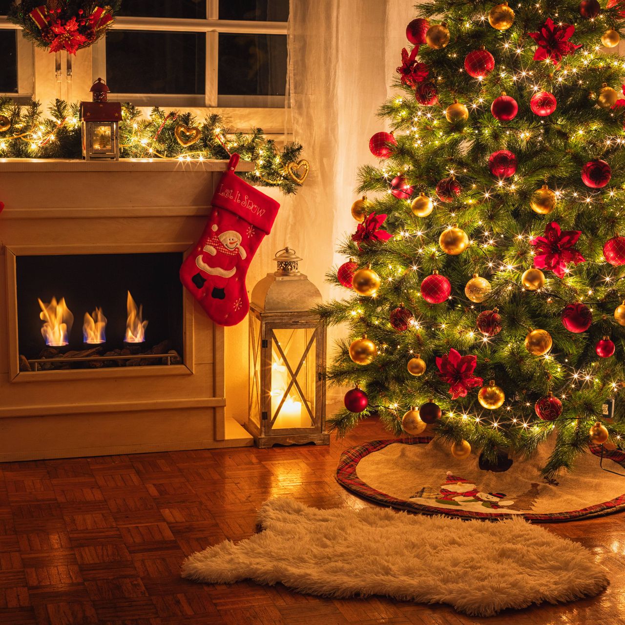 A decorated christmas tree next to a fireplace with a stocking