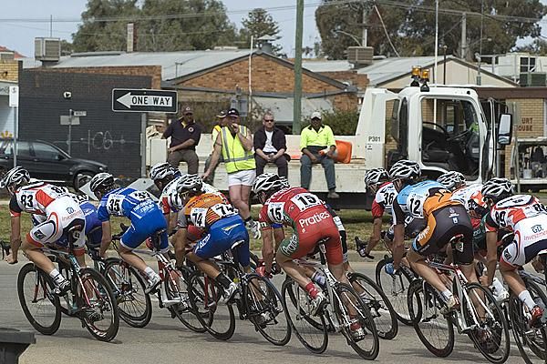 Riders corner in Robinvale with local workers taking a break to take in the action.