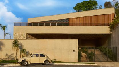 Casa Prática, by Estúdio Zargos, with VW Beetle parked out front