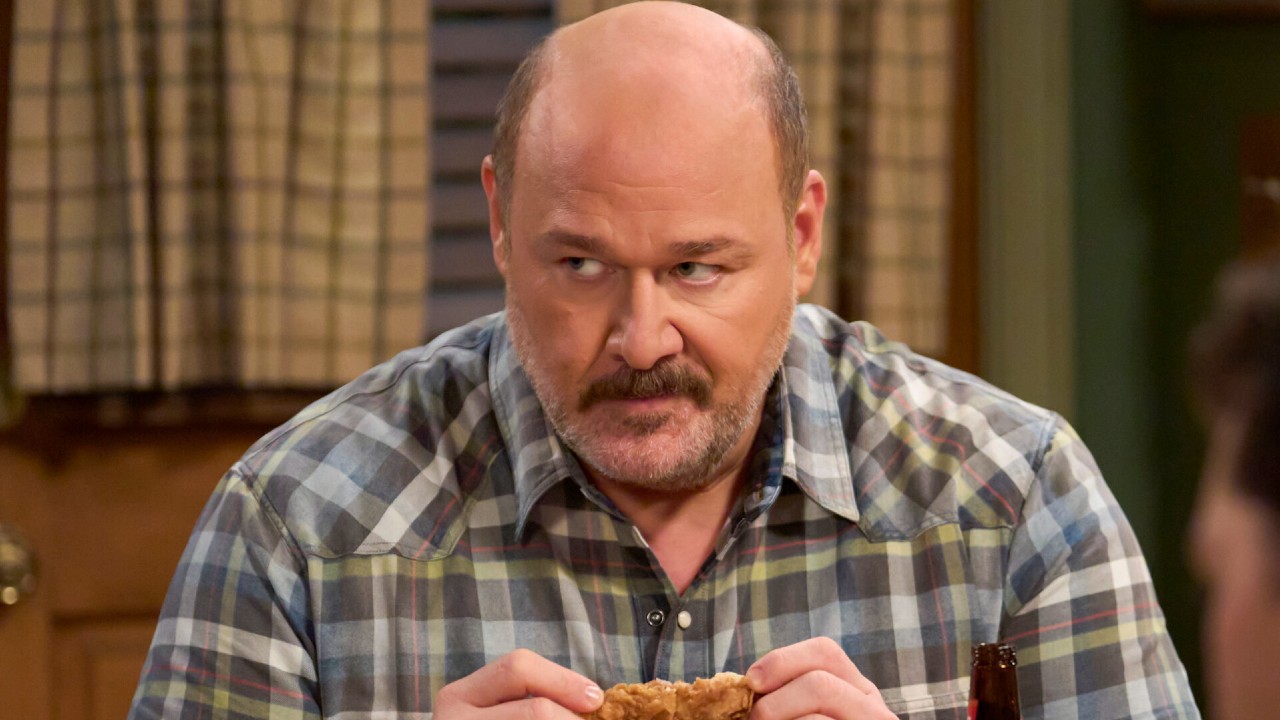 Jim looking around while eating chicken