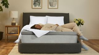 best mattress topper: Casper Comfy Mattress Topper, featuring a woman resting on her back enjoying said topper on her bed