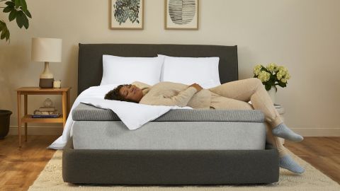 Casper Comfy Mattress Topper, featuring a woman resting on her back enjoying said topper on her bed