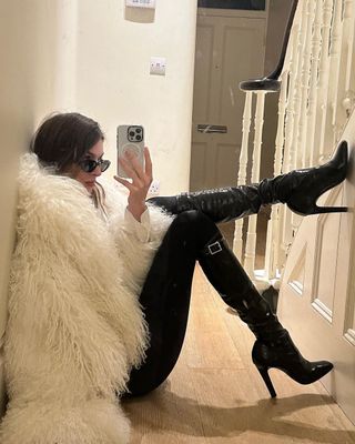 @camillecharriere wearing pointed toe patent boots