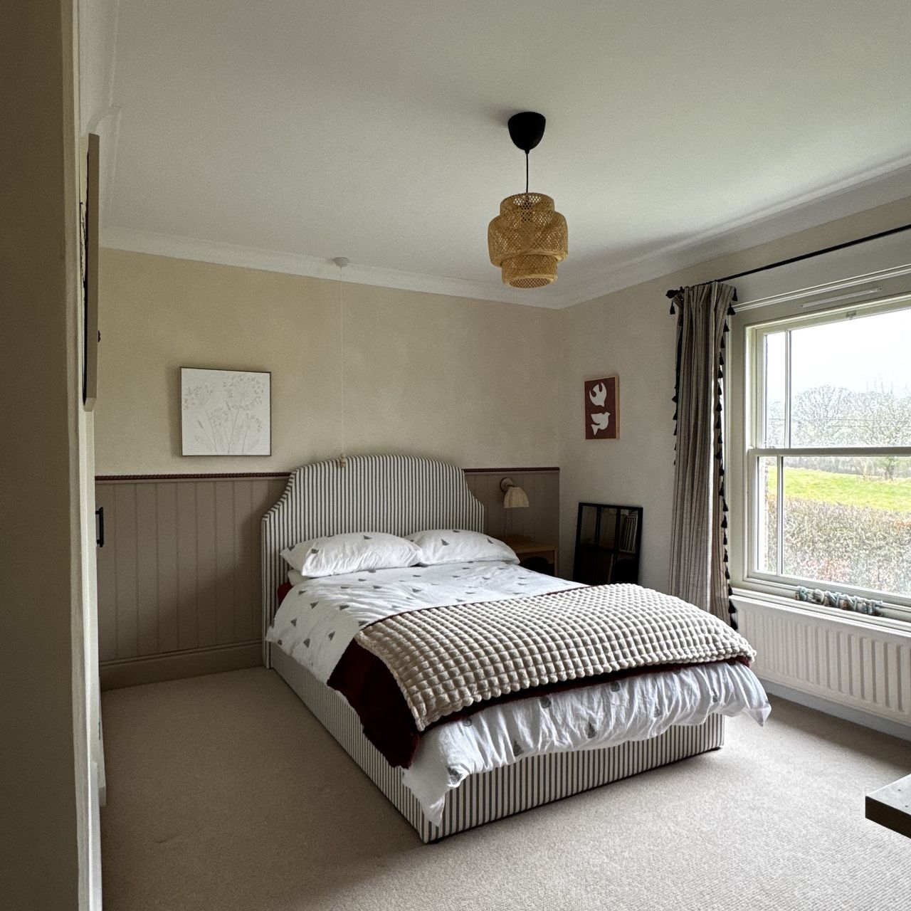 neutral bedroom with striped bed