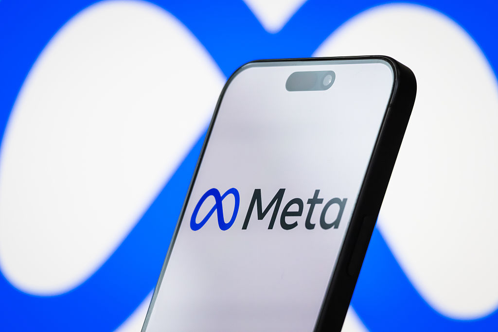 the logo of Meta Platforms, Inc. is displayed on a smartphone screen, with the company's infinity loop-style branding visible in the background