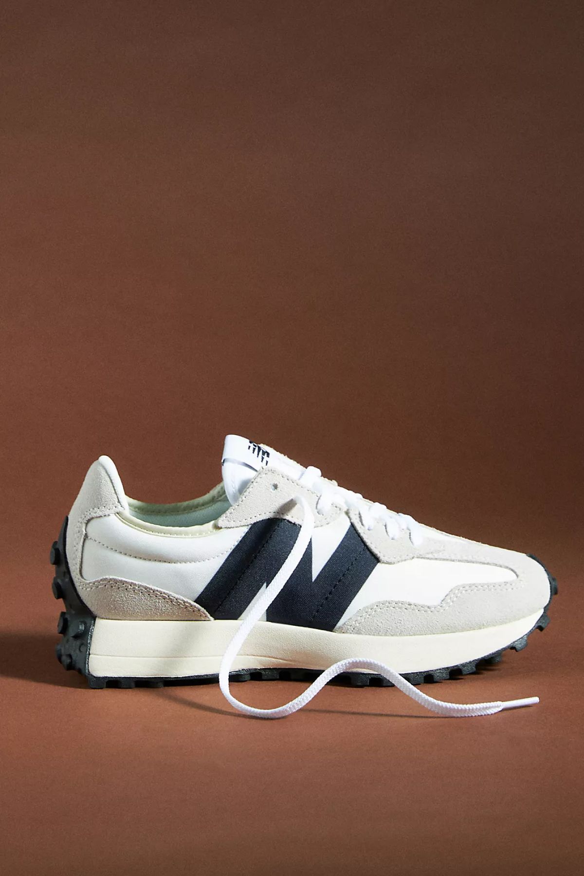 New Balance 327 Sneakers in front of a backdrop