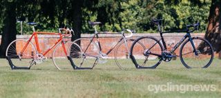 three specialized allez on a lawn in front of trees and a brick wall