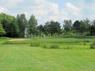 A pond protects the attractive short hole at six