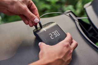 Weber Connect smart barbecue hub hand plugging temperature probes into the hub
