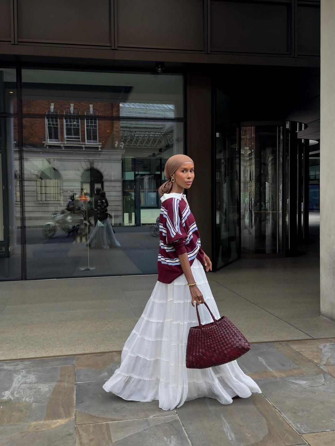 Basma Kahie wearing a burgundy bag