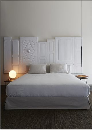 Bedroom with white wooden headboard