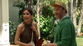 Rose Byrne and Seth Rogen face each other while laughing at something off screen