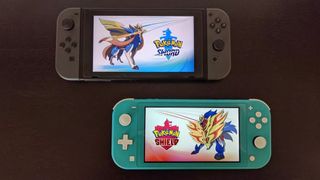 Nintendo Switch and Switch Lite with Pokemon Sword and Shield on screens. 