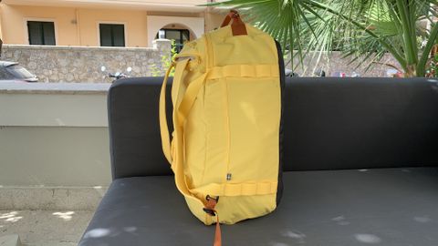 Fjallraven High Coast Duffel 36 in yellow sitting on sun lounger