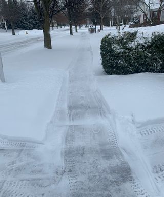 snow blower used to clear sidewalk of snow