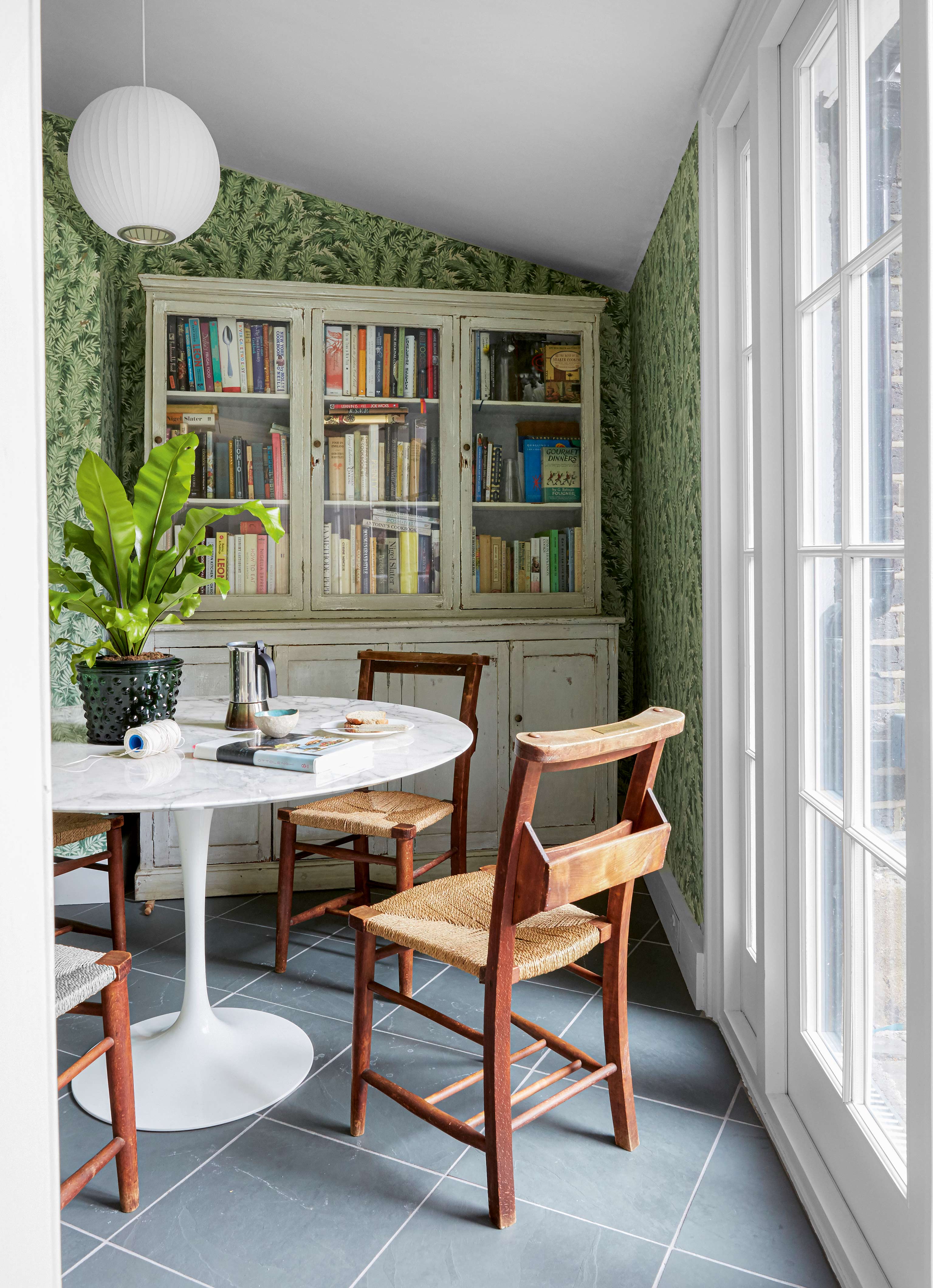 Small wallpapered dining room with vintage dresser