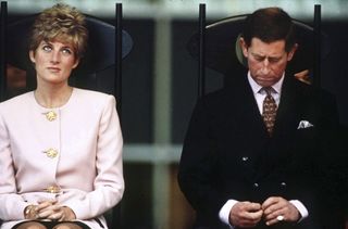 Princess Diana and Prince Charles sat on chairs looking unhappy on a tour of Canada