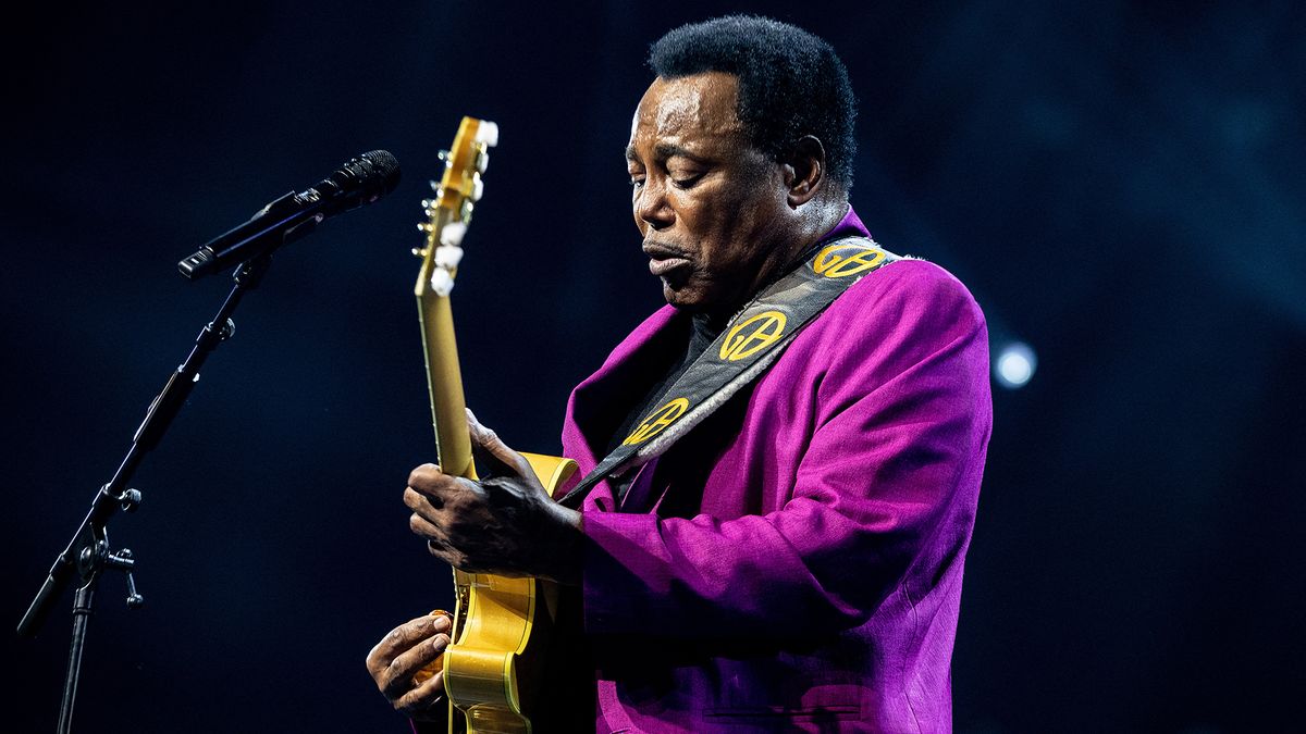 George Benson playing guitar onstage in 2022