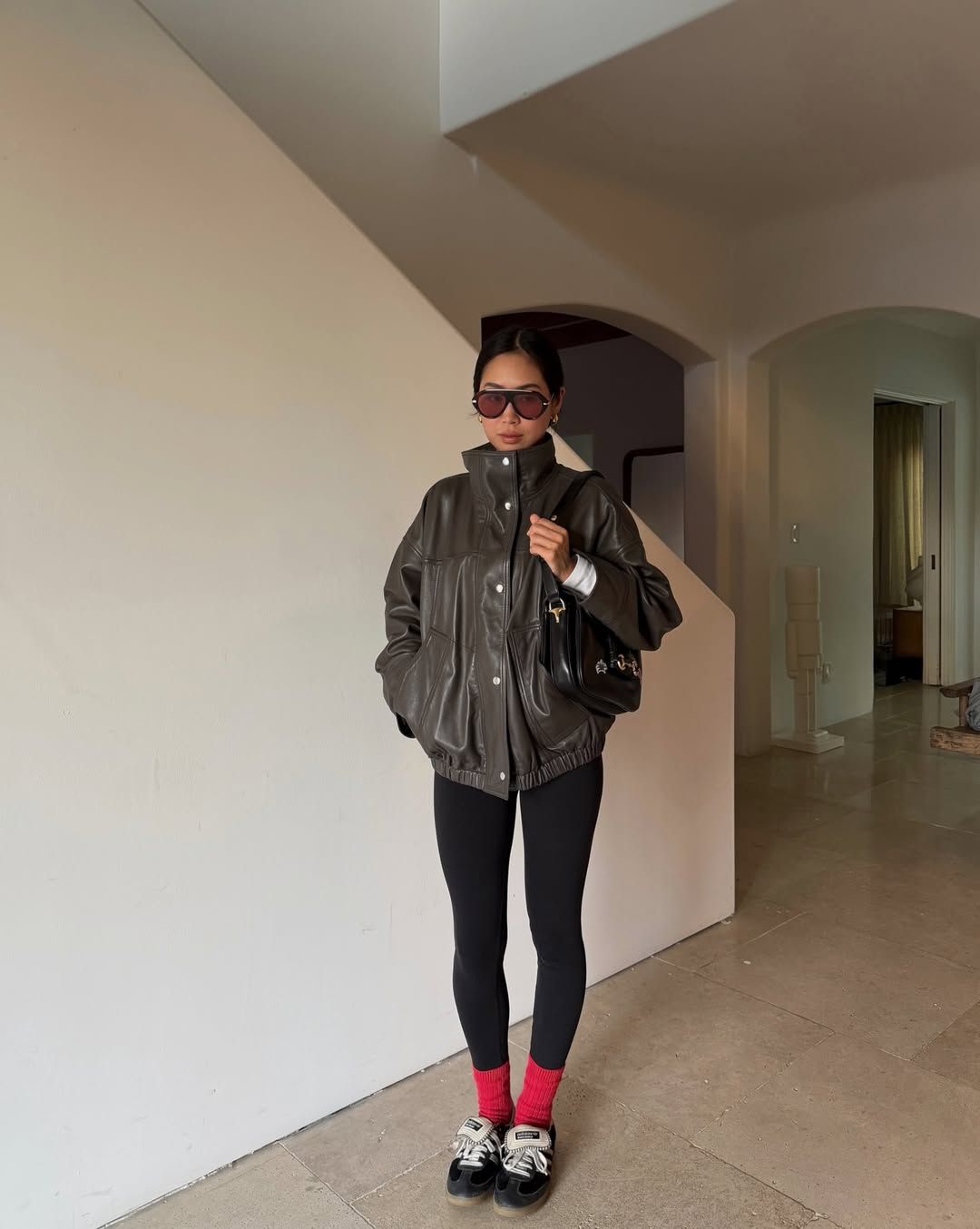 Aimee Song in a leather funnel-neck jacket