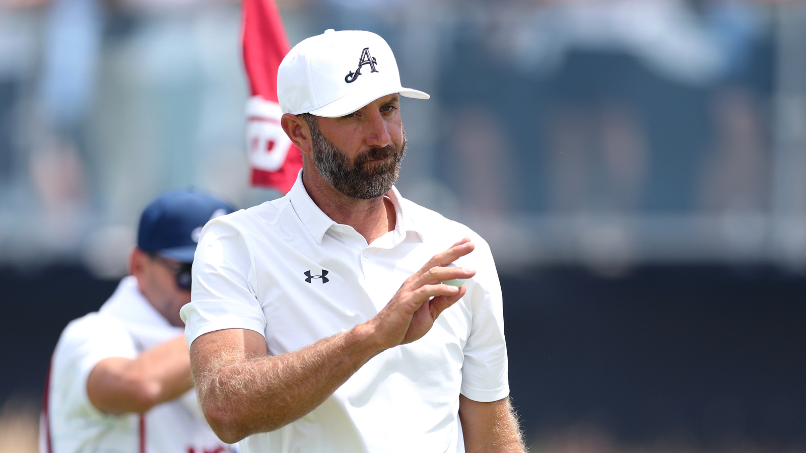 Dustin Johnson waves to the crowd