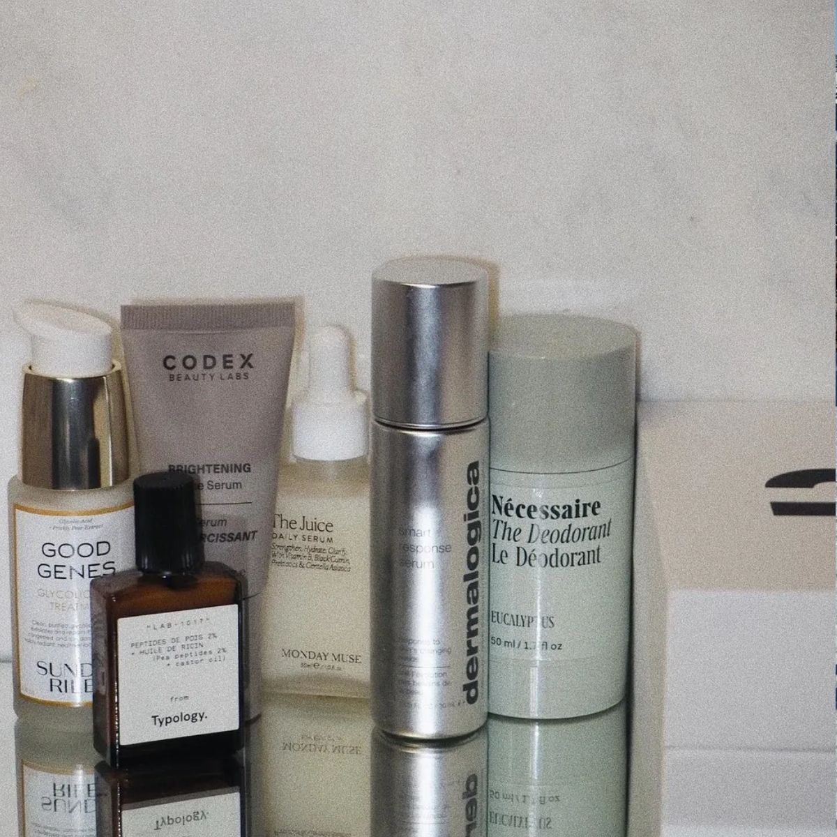 A picture of skincare products on a mirrored table