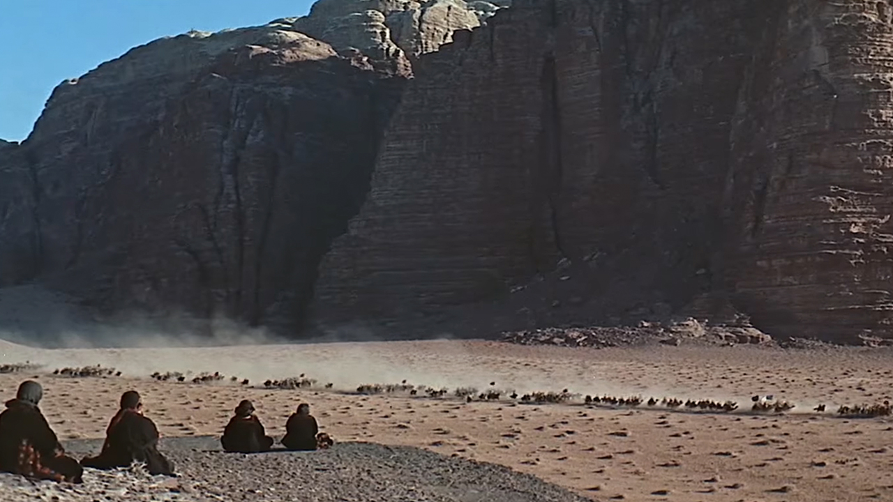 A vista of the desert with some mountains in the background in Lawrence Of Arabia