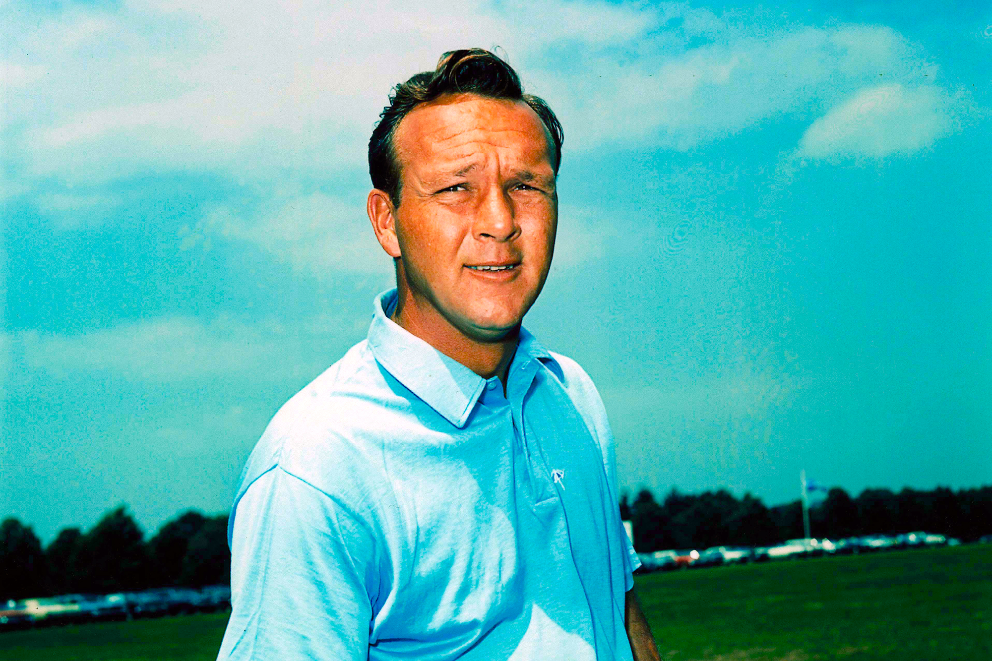 Headshot of Arnold Palmer in a blue polo shirt