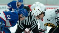 From left to right: Shane and Ilya facing off against each other during a hockey game. 