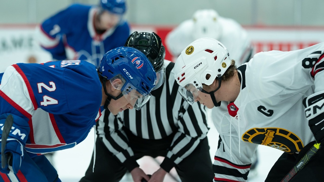 From left to right: Shane and Ilya facing off against each other during a hockey game. 